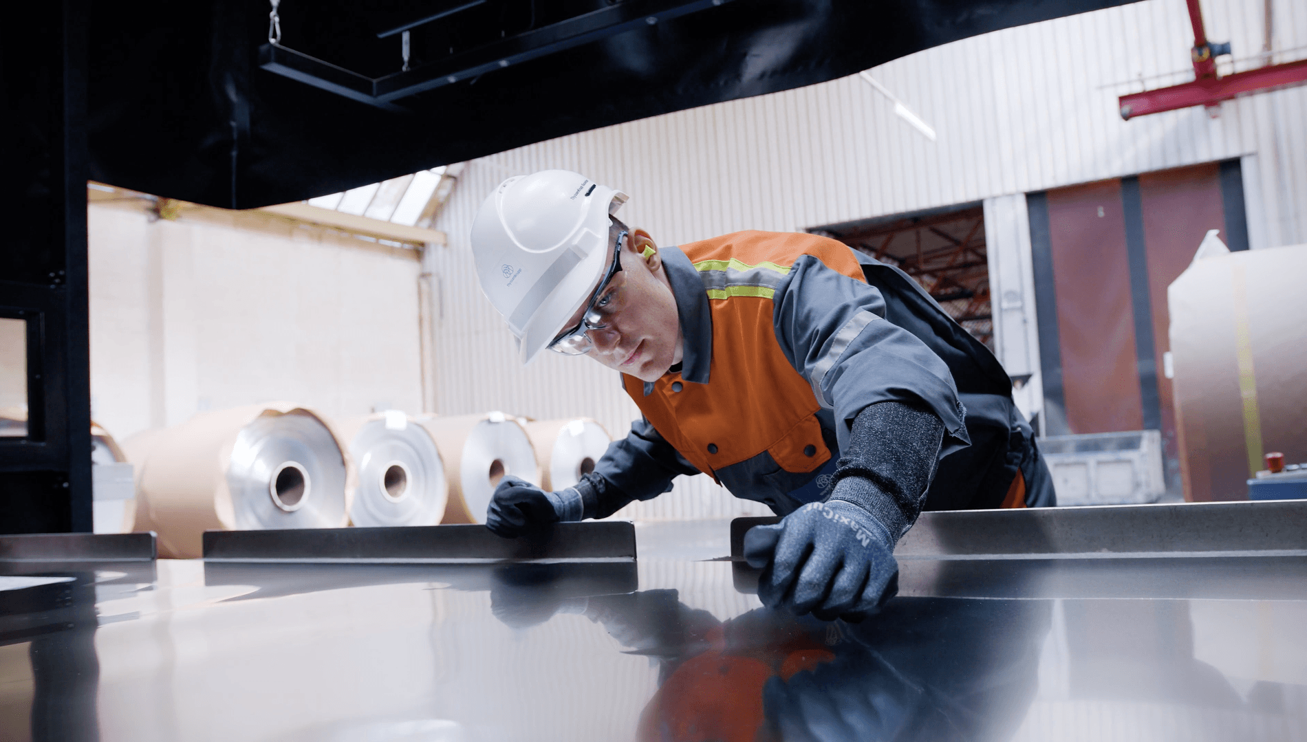 Operator reviewing an AI-flagged defect at an inspection station on a connected device