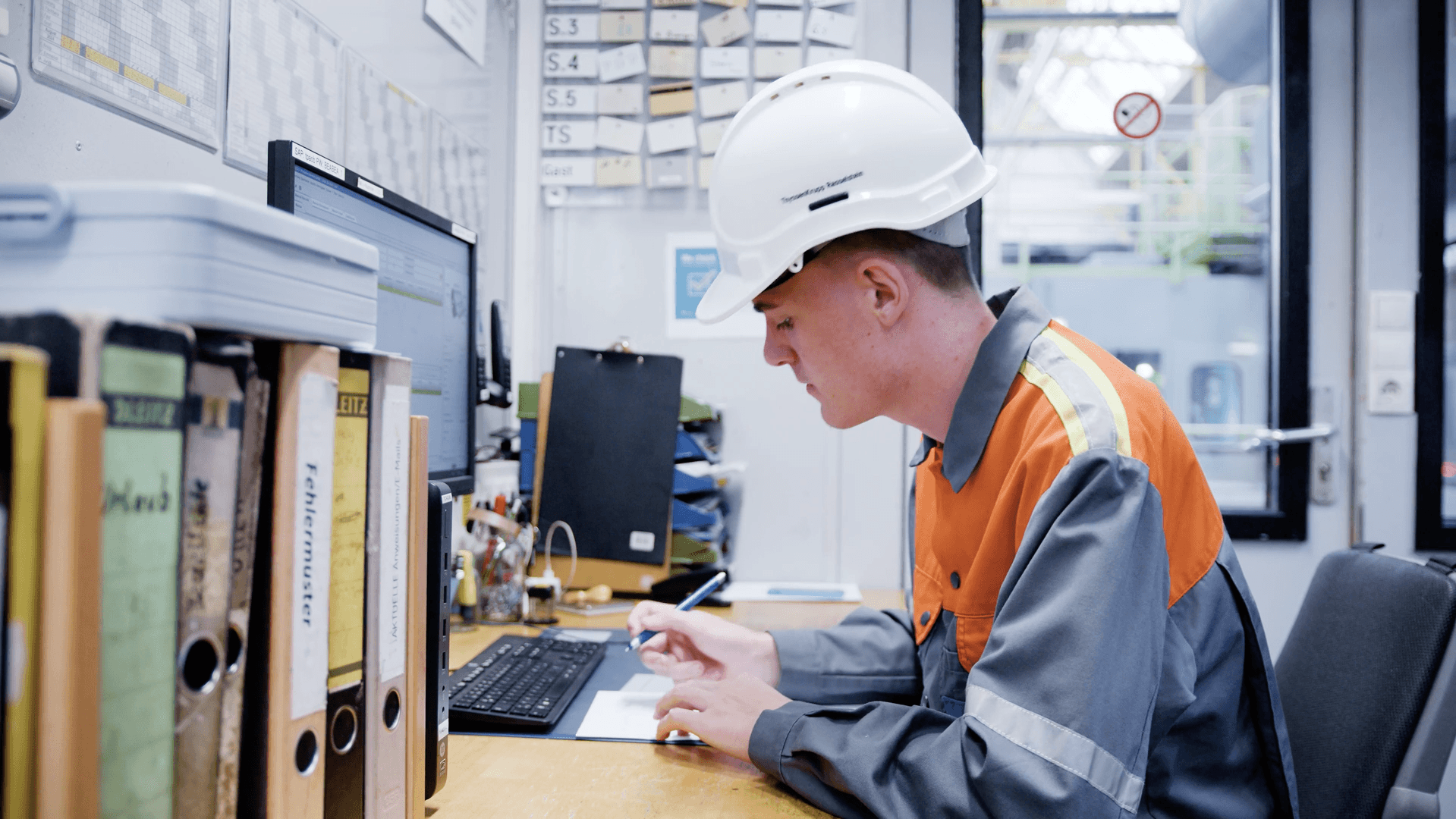 Maintenance planner writing a digital preventive maintenance plan on the shopfloor