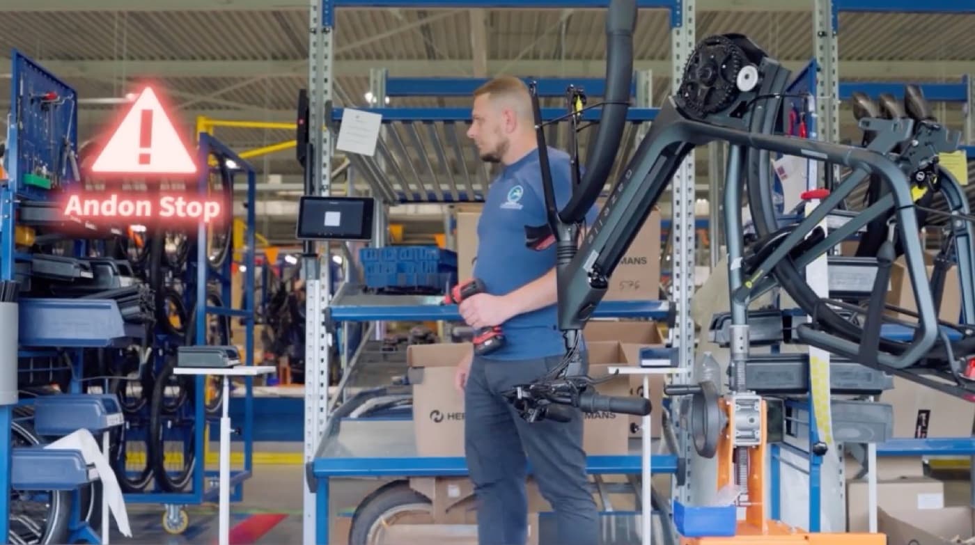 Operator raising a digital Andon stop on the shop floor