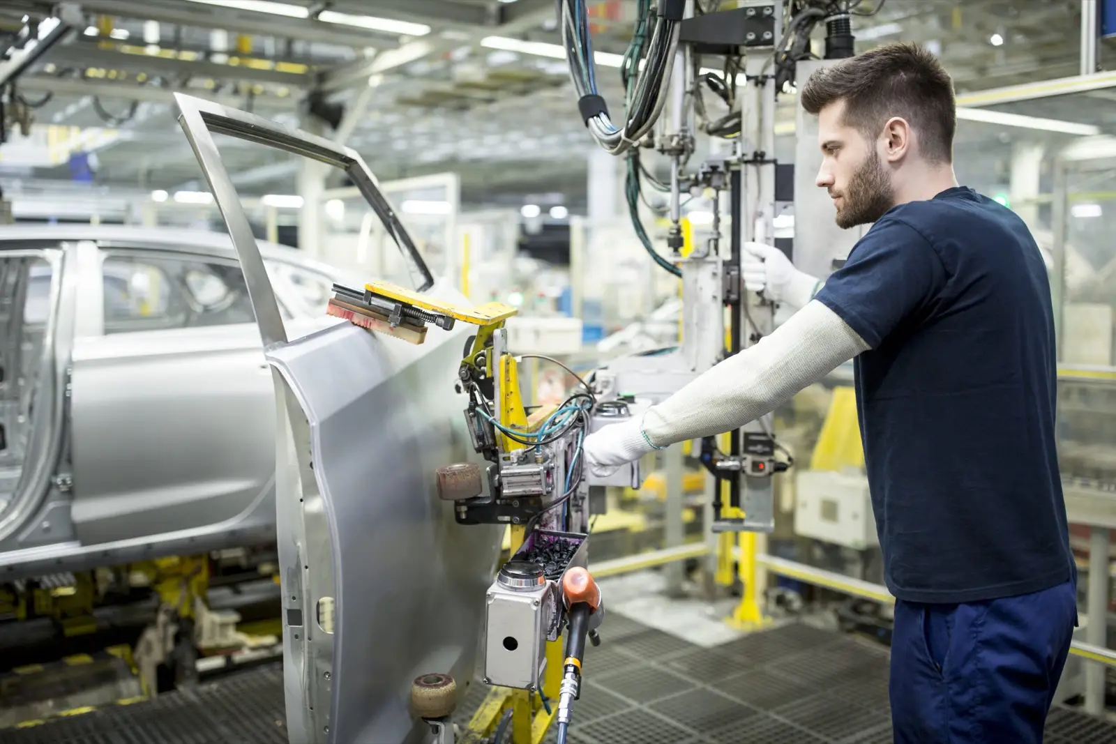 Worker in modern automotive factory using connected worker platform