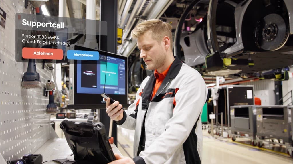 Quality inspector reviewing a support call for a damaged rim on the assembly line